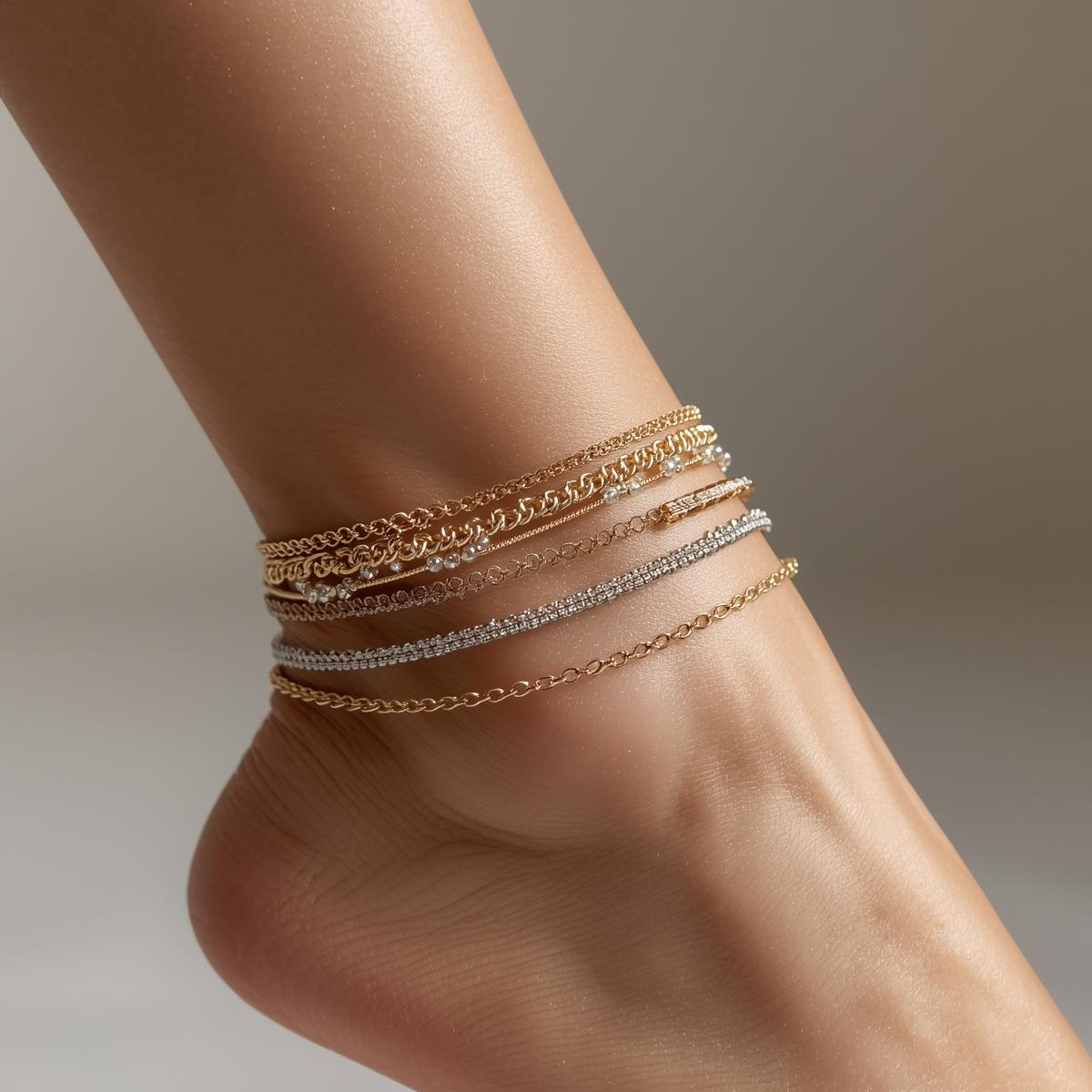Close-up of ankle wearing layered delicate anklets, neutral background. Gold and silver chains, beaded details. Soft lighting, minimalist styling, professional jewelry photography