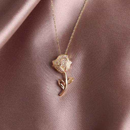 rose necklace on tan silk