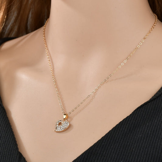 gold heart embezzled necklace on a woman