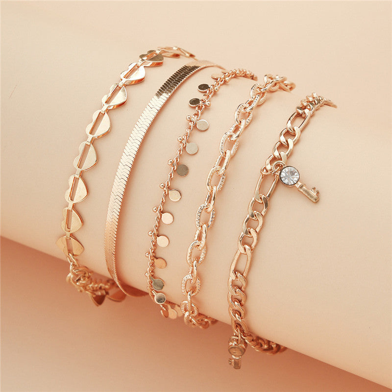 5-Piece Boho Gold Anklet Set - Layered Chain Stack with Heart and Charm Details