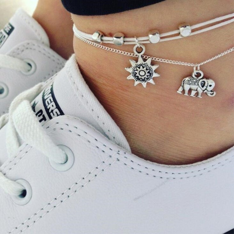 Sun and Elephant Multi-Layer Anklet on womans leg