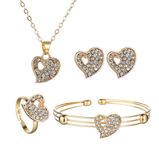 5 piece gold heart embezzled jewelry set on white