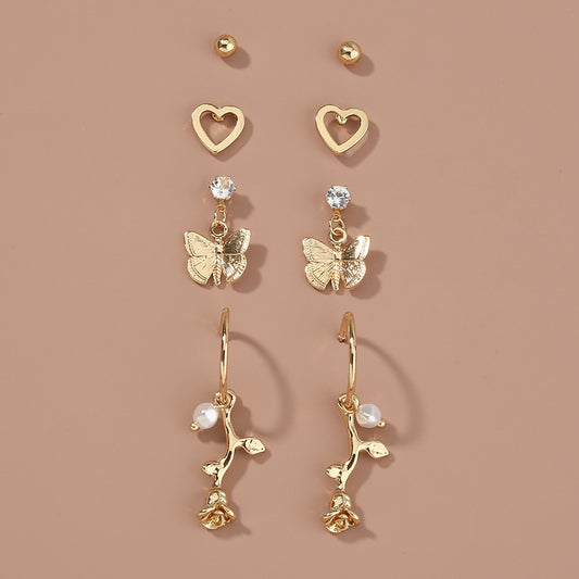 flowers and butterflies earring set on tan background